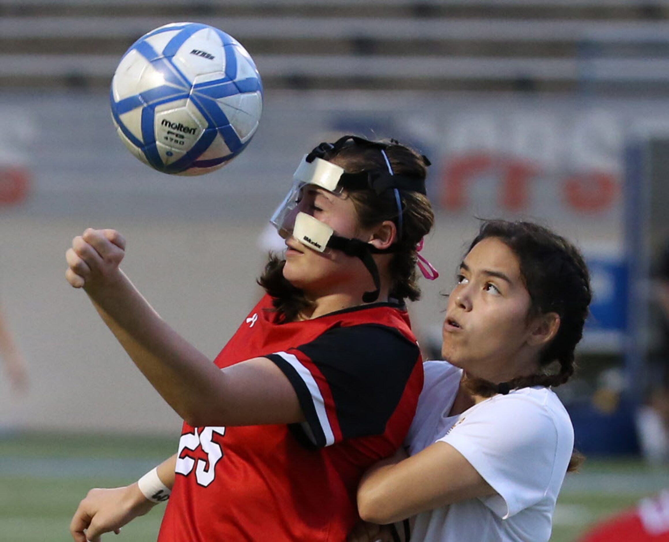 Ursuline Academys Alex Arenas (25) defends the ball against Daphne De La Piedra (10) in the...