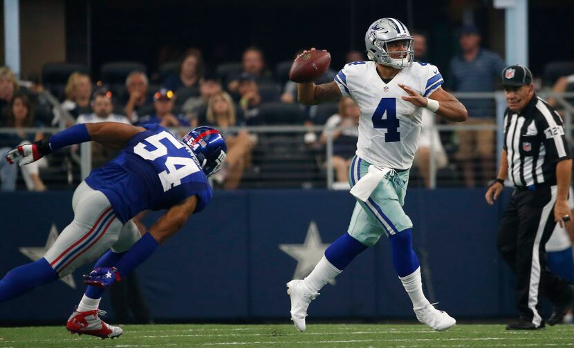 Dallas Cowboys quarterback Dak Prescott (4) is chased by  New York Giants defensive end...