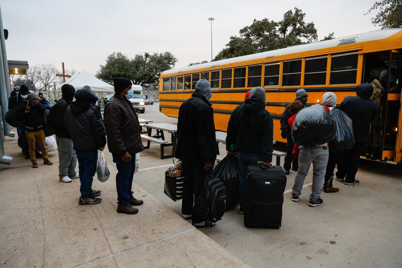 People load into a bus at OurCalling as they head to Kay Bailey Hutchison Convention Center...