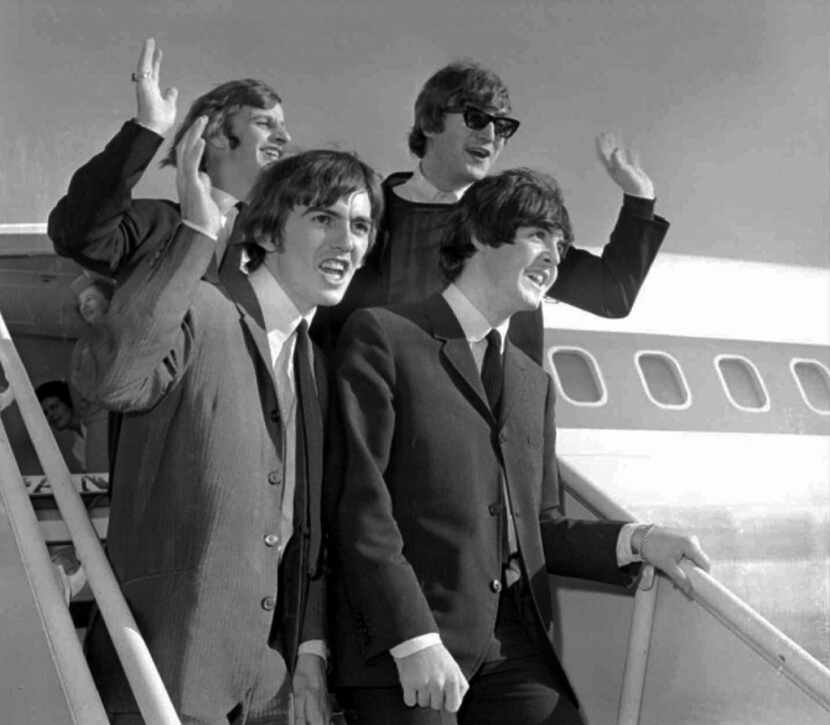 The Beatles wave after arriving at the San Francisco airport Aug. 18, 1964, to begin an...