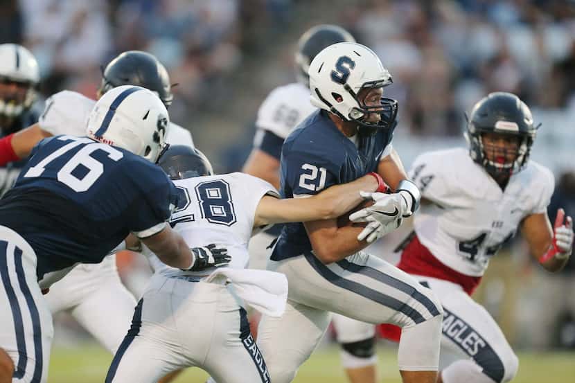 Fort Worth All Saints player Brendan Harmon (21) carries the ball in the first half during a...