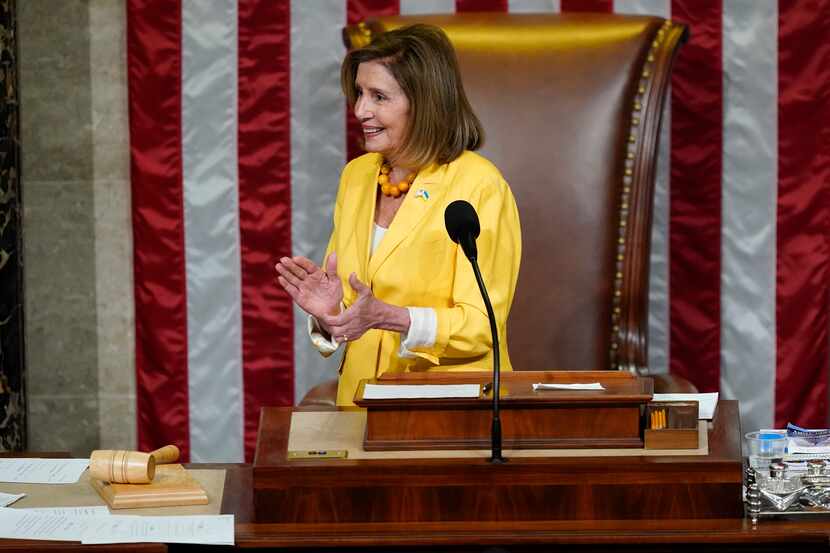 House Speaker Nancy Pelosi of Calif., claps after finishing the vote to approve the...
