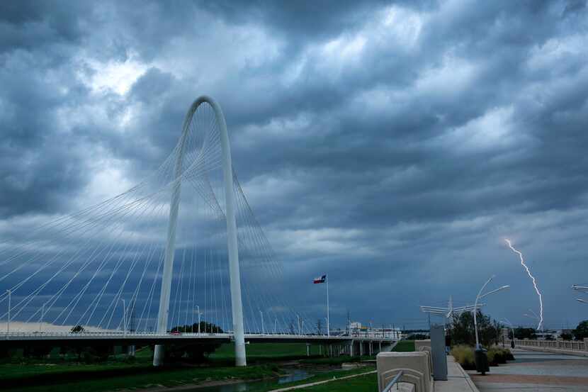 Lightning strikes in West Dallas as a thunderstorms roll past the Margaret Hunt Hill Bridge...