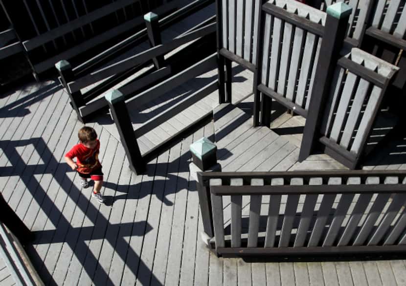 Jace Cantu, 3, runs through Pirate Cove at Wylie Founders Park. The structure is...
