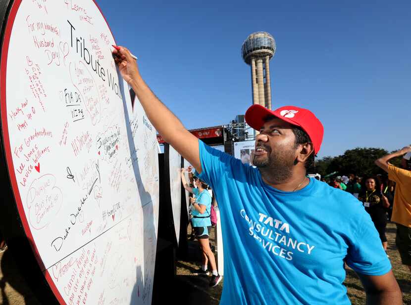 Sathish Kaliamoorthi signs a tribute wall during the American Heart Association's Annual...