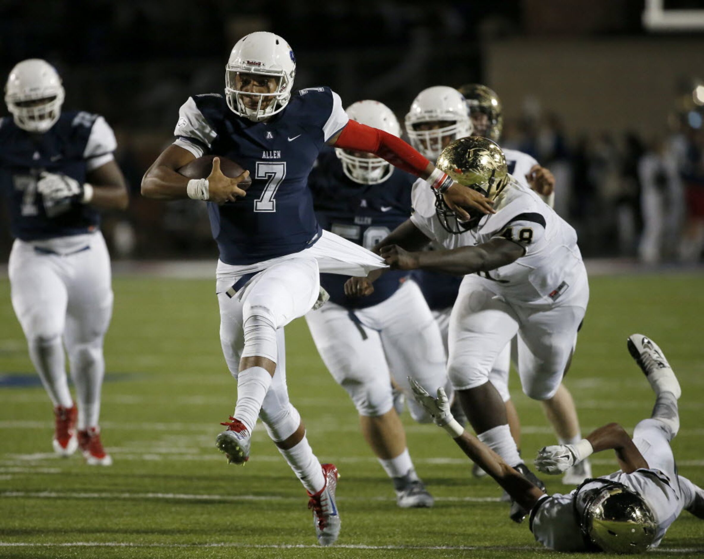 Plano East's Dieon Davis (48) pulls a jersey of Allen's Seth Green (7) during the first half...