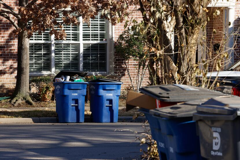 Trash and recycling bins sit along Throckmorton Street and an alleyway of Hawthorne Avenue...