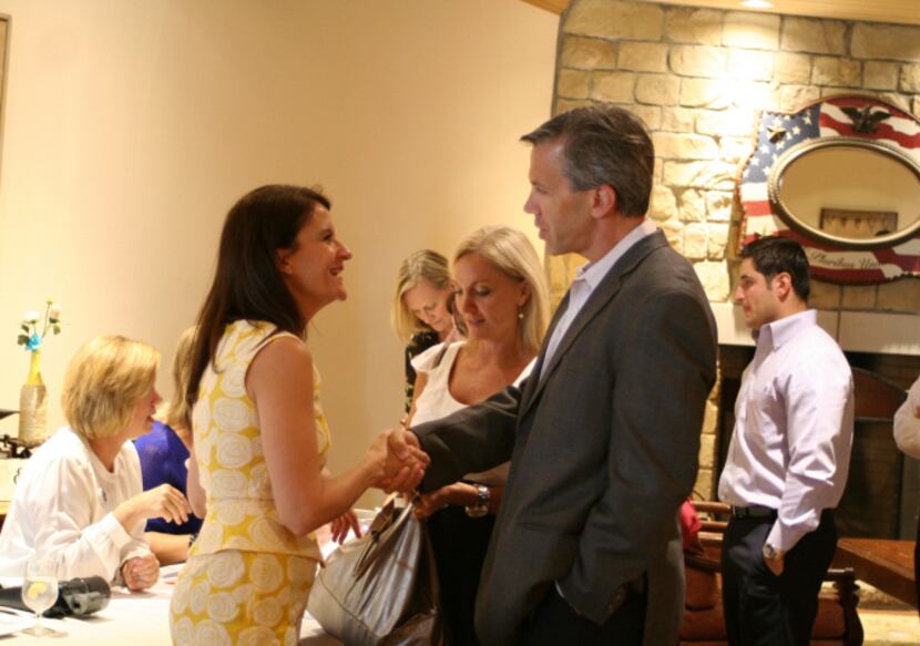 Walker visits with new Flower Mound Chamber members Stephanie Clopton and Steve Crispin of...