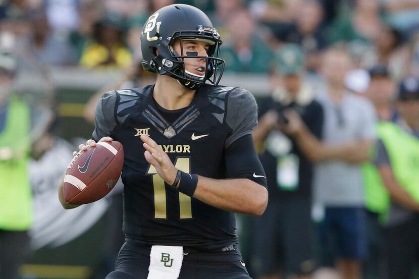 Baylor quarterback Zach Smith (11) looks to pass during the first half of an NCAA college...