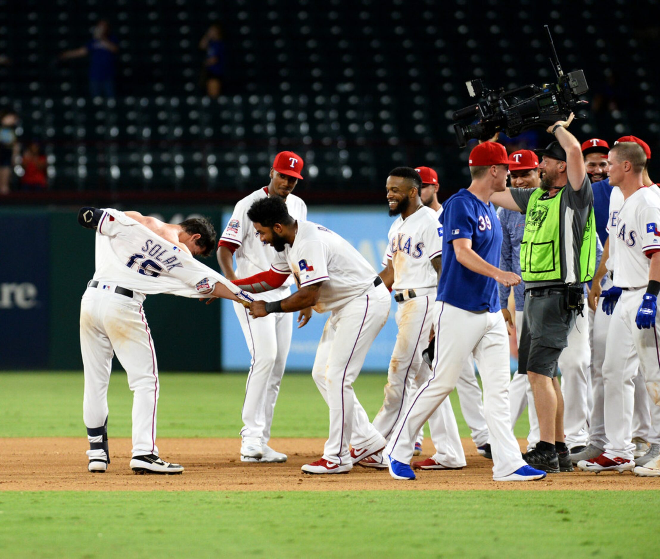 ARLINGTON, TEXAS - AUGUST 20: Nick Solak #15 of the Texas Rangers celebrates with his...