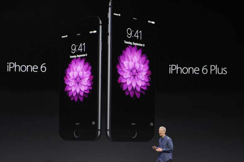 Tim Cook, chief executive officer of Apple Inc., unveils the iPhone 6 and iPhone 6 Plus...