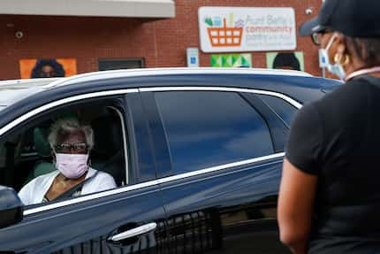 Mary Brashear, 89, picks up groceries at the food pantry run by St. Philip's School and...