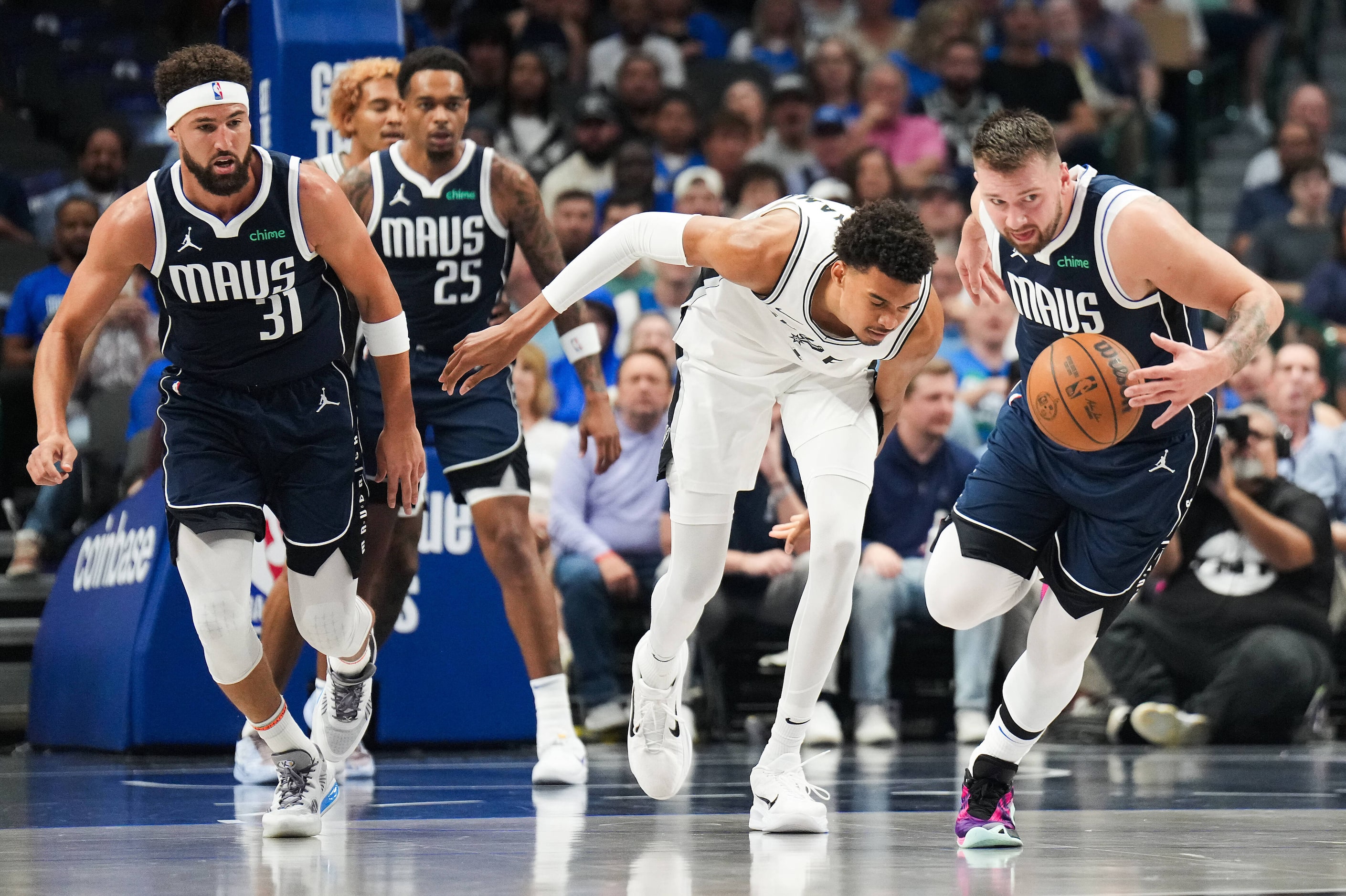 Dallas Mavericks guard Luka Doncic (77) takes the ball away from San Antonio Spurs center...