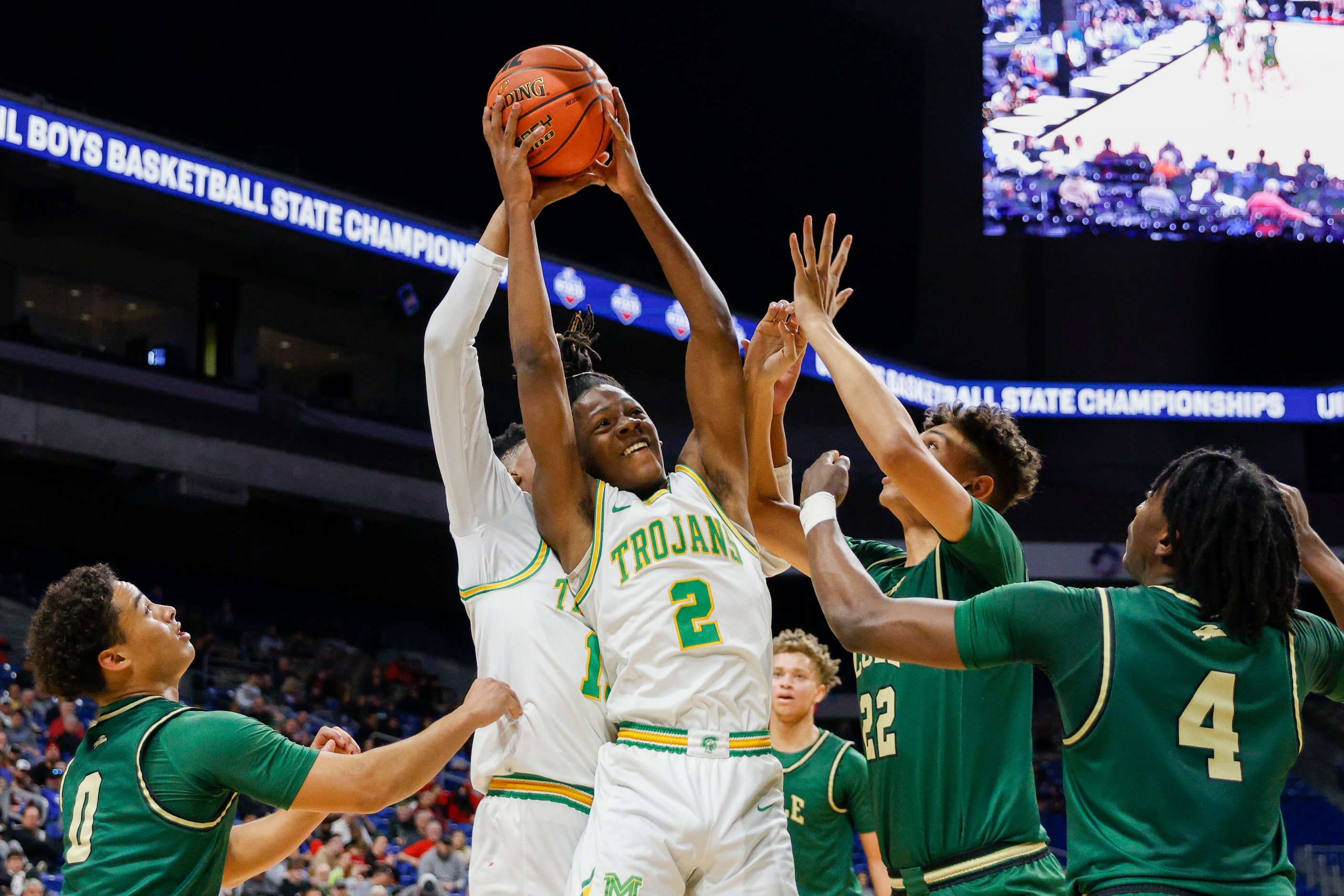 Madison guard Kardae Turner (2) reaches for a rebound over Madison forward Rodney Geter...