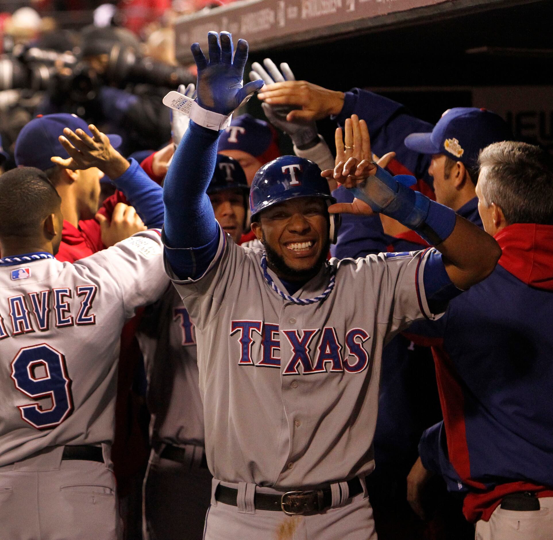 Texas Rangers' Elvis Andrus smiles as he looks on at play during a