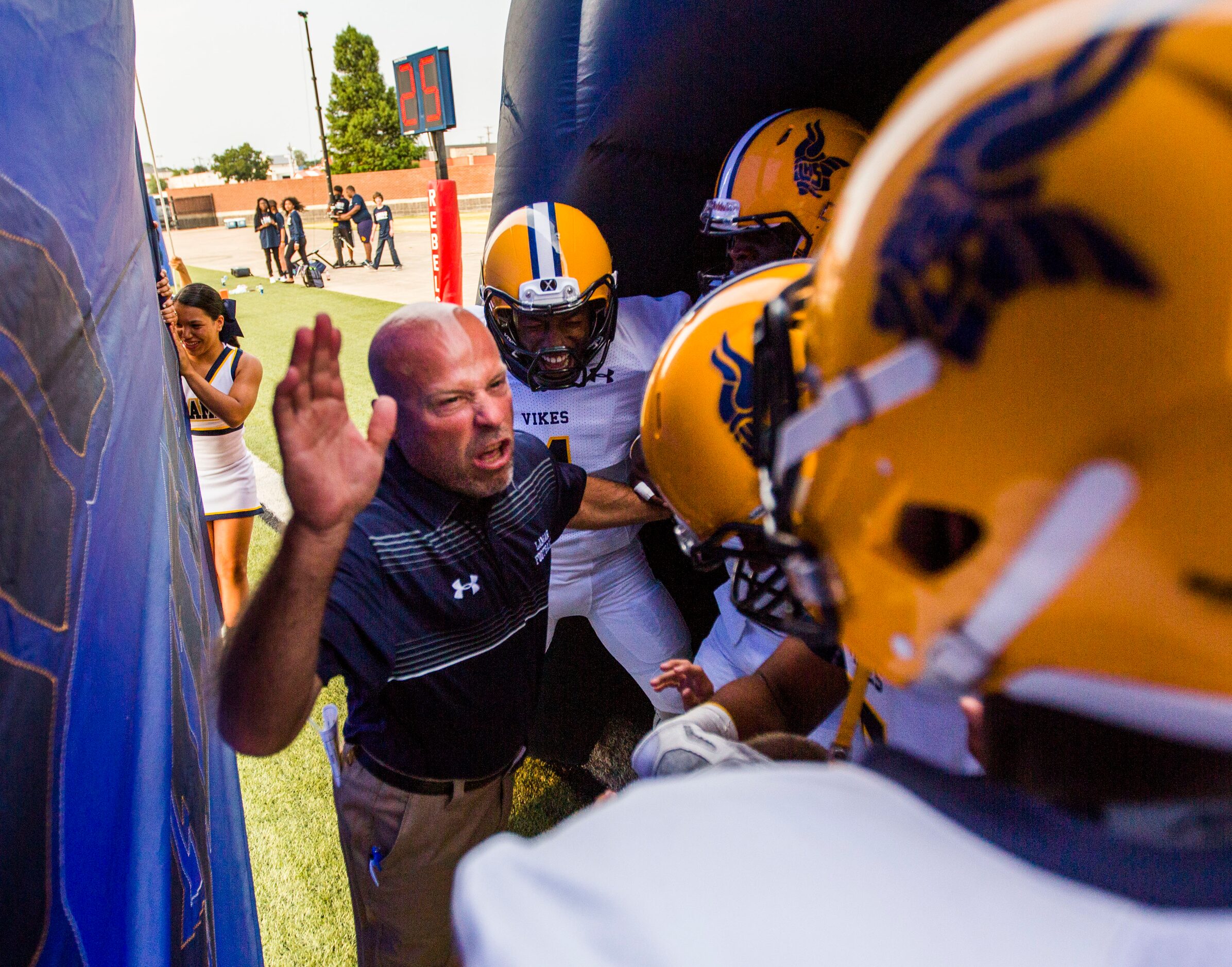 Arlington Lamar High School head coach Laban DeLay hypes up his team before their game...