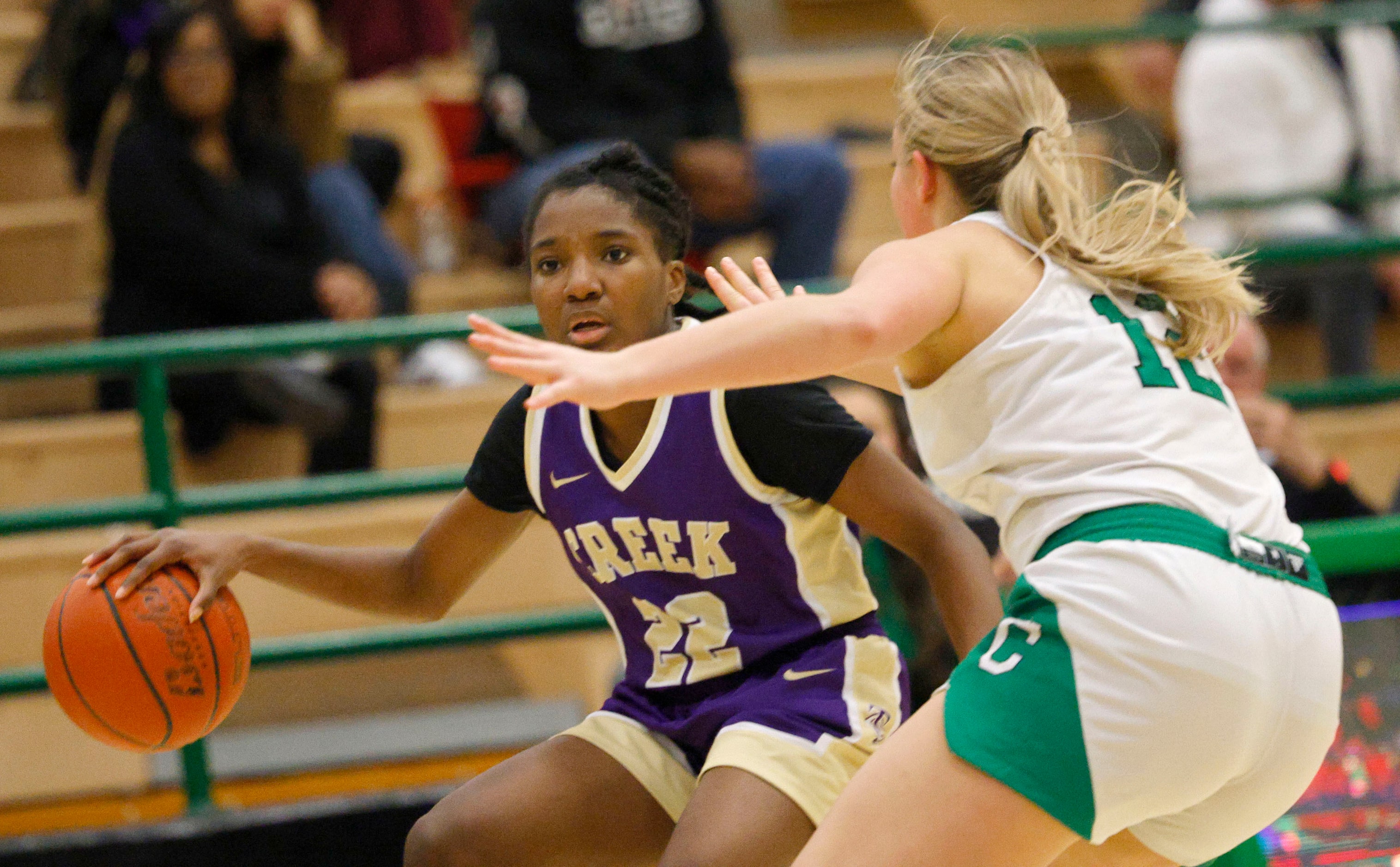 Keller Timber Creek's London Lumsden (22) tries to drive past Southlake Carroll's Taryn...