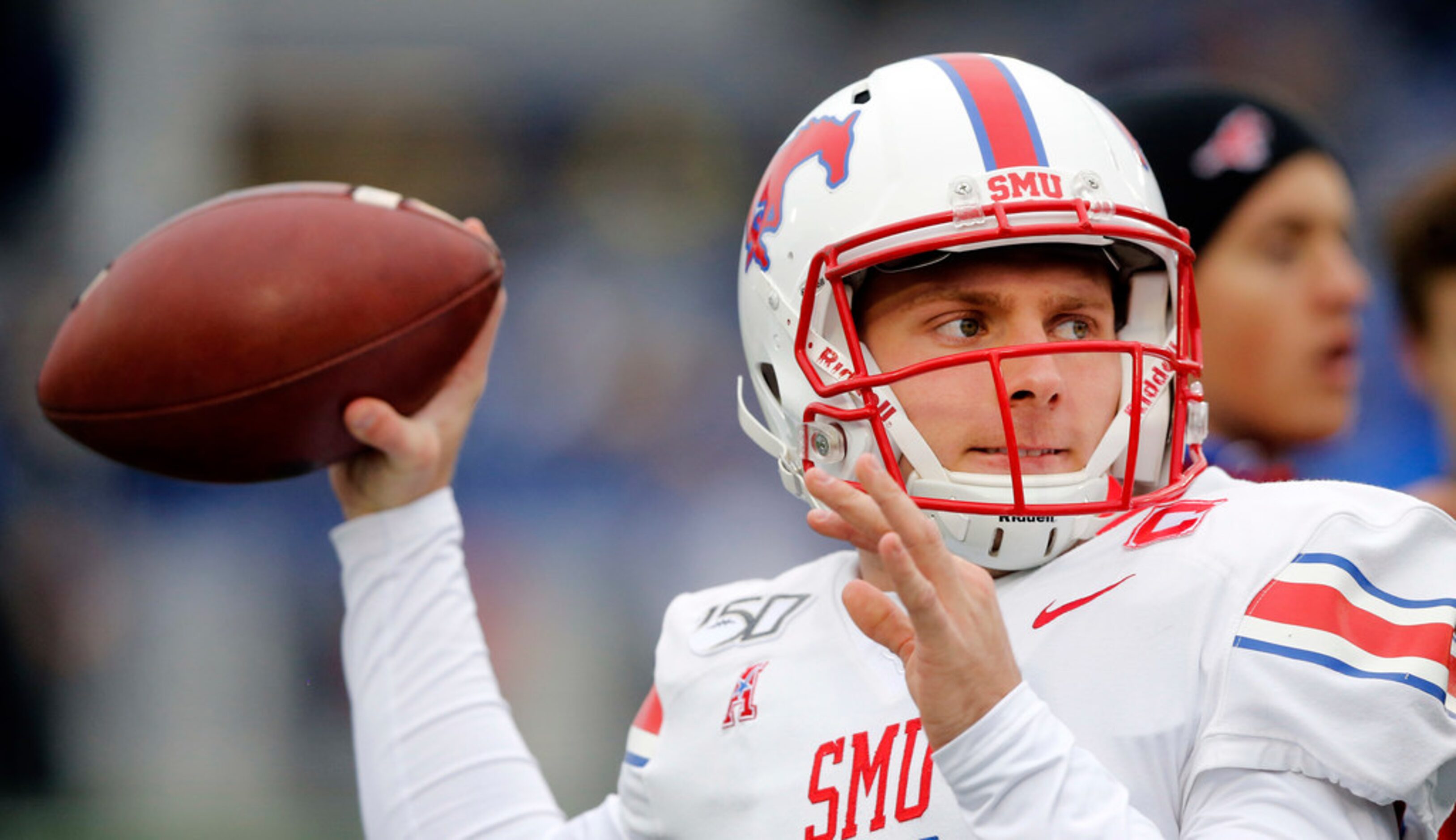 Southern Methodist Mustangs quarterback Shane Buechele (7) throws passes during pregame...