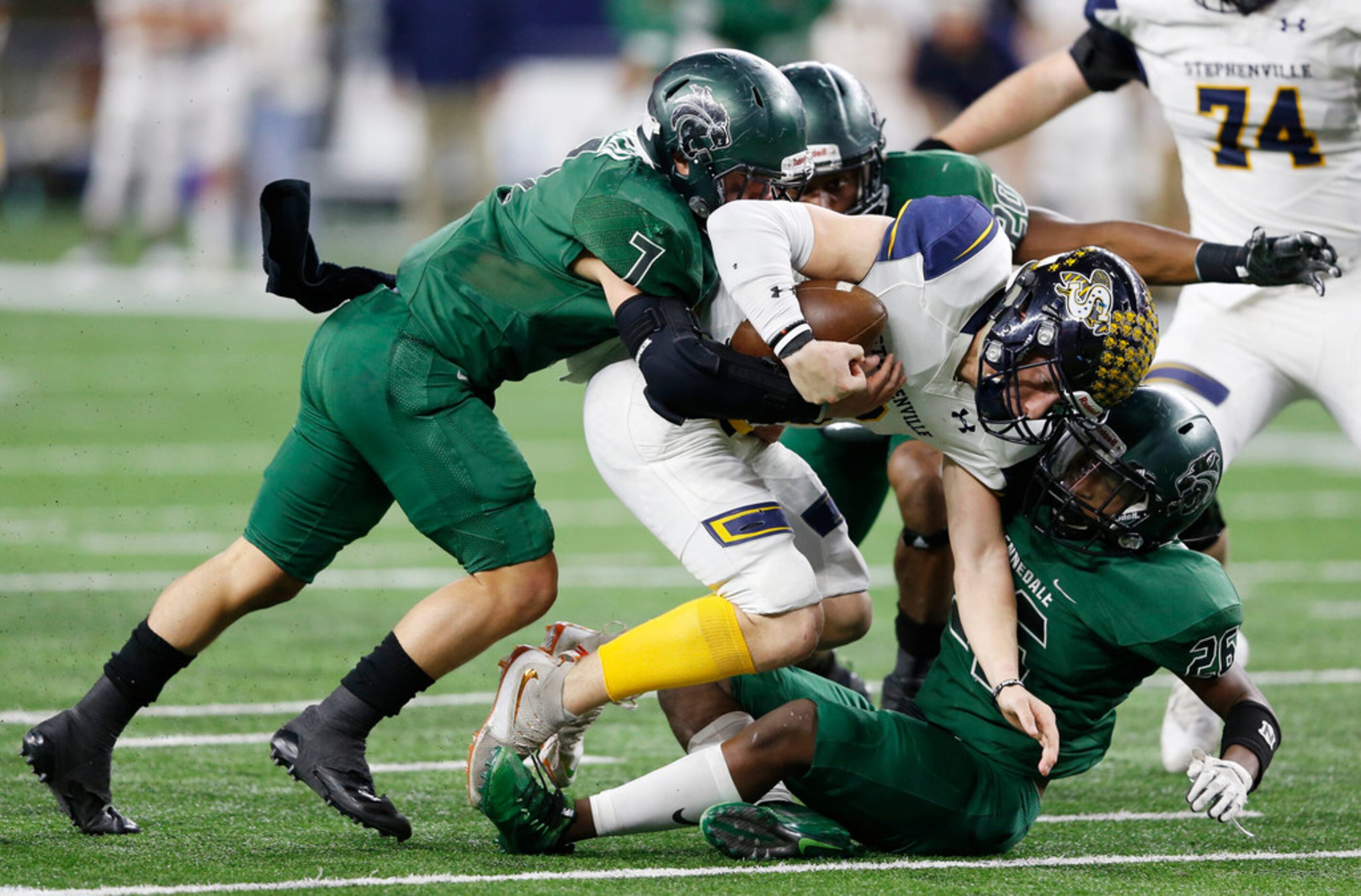 Kennedale's Ector Rivera (7) and Jalen Myers (26) sack Stephenville's Easton Jones (3)...