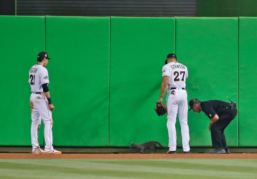 Miami Marlins center fielder Christian Yelich (21) right fielder Giancarlo Stanton (27) and...