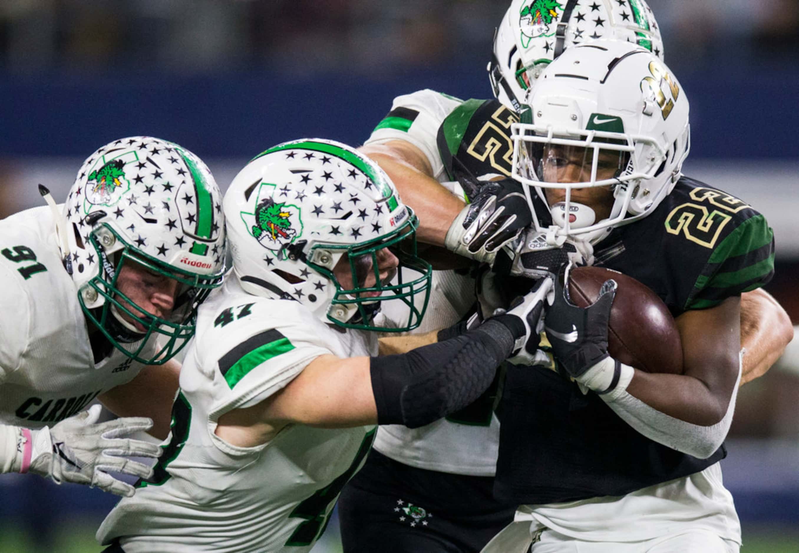 DeSoto running back  Jyison Brown (22) is tackled by Southlake Carroll defenders during the...