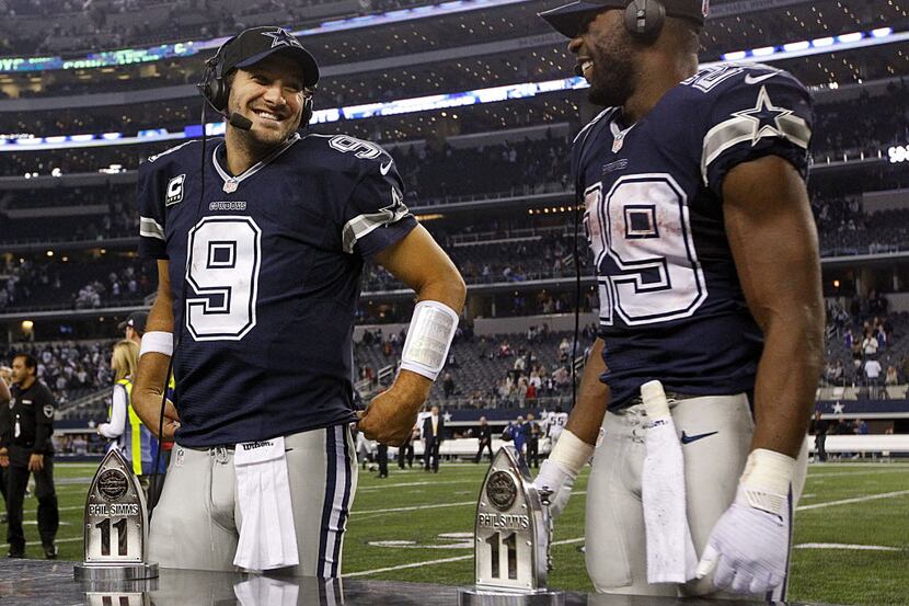 Dallas Cowboys quarterback Tony Romo (9) and running back DeMarco Murray (29) received the...