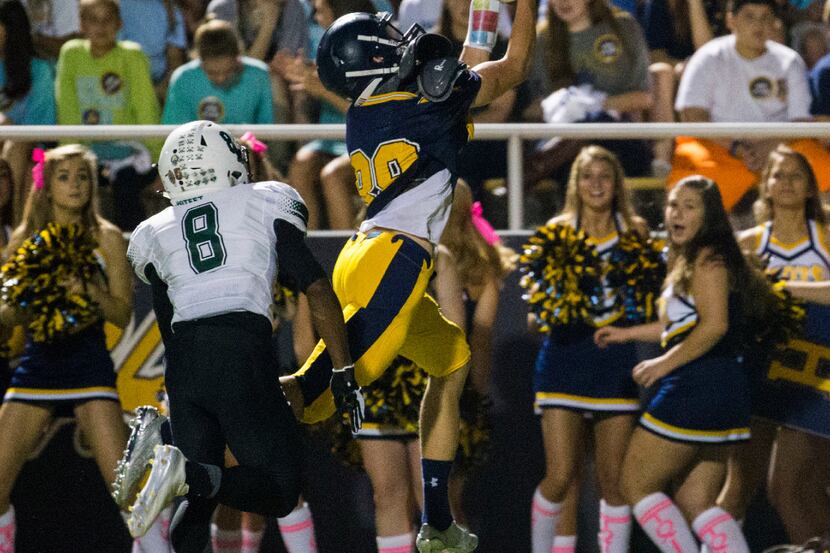 Highland Park wide receiver Cade Saustad (88) jumps up to catch a pass with Mesquite Poteet...