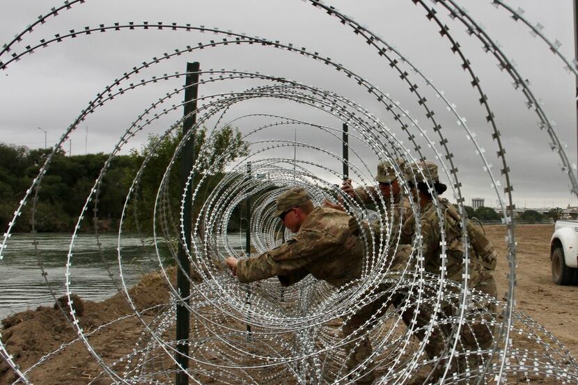Soldiers from the Kentucky-based 19th Engineer Battalion installed barbed wire fences on the...