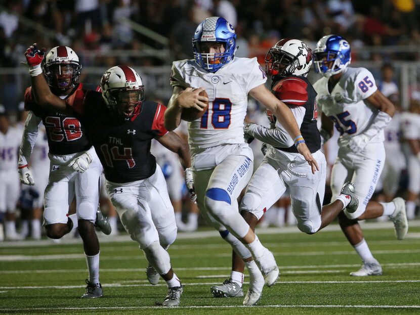 Cedar Hill players are unable to reach Bishop Gorman quarterback Tate Martell (18) as...