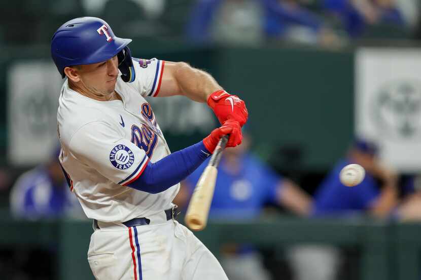 Texas Rangers' Wyatt Langford swings and misses during the eighth inning of the team's...