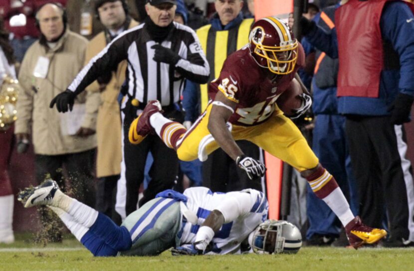 Washington Redskins running back Alfred Morris (46) leaps over Dallas Cowboys cornerback...