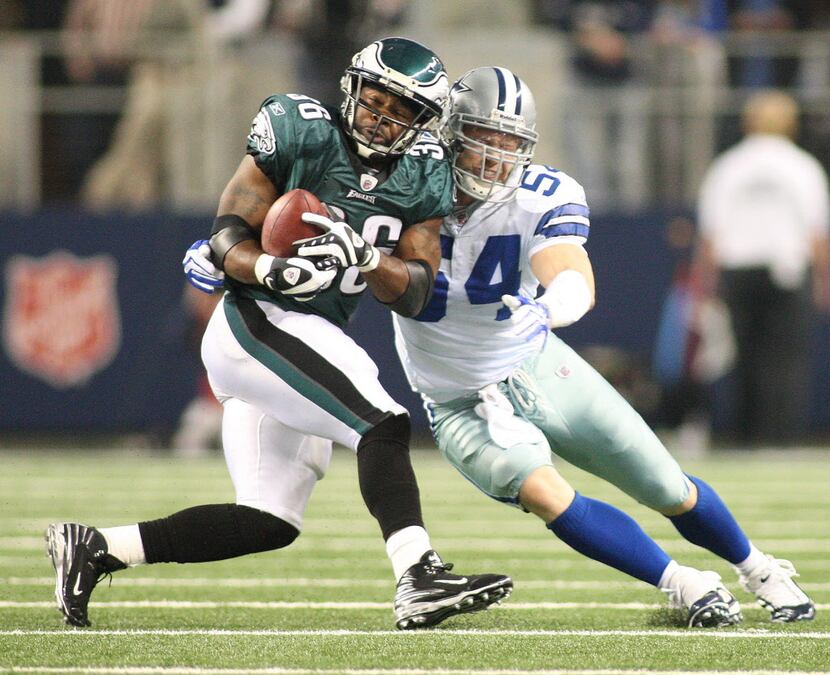 Eagles running back Brian Westbrook is stopped by Cowboys linebacker Bobby Carpenter as the...