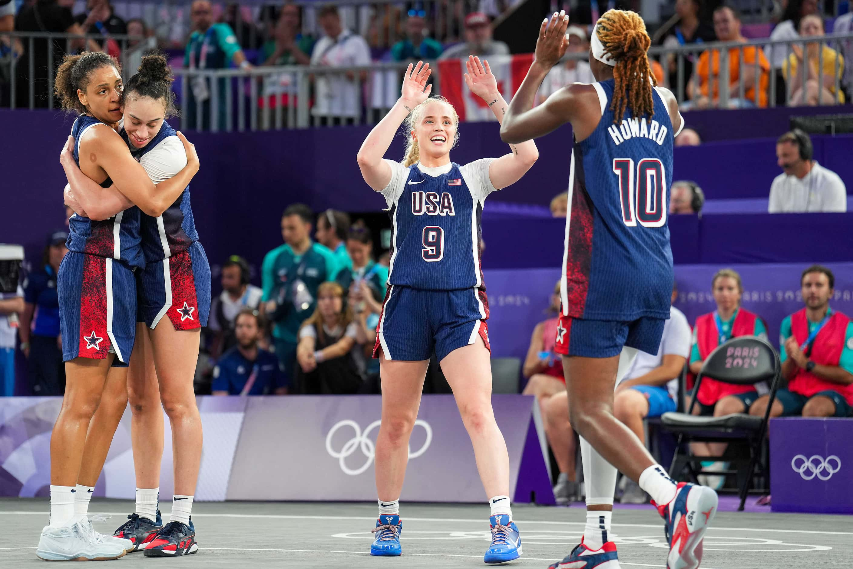 Hailey van Lith (9) of the United States celebrates with Rhyne Howard (10) as Cierra Burdick...