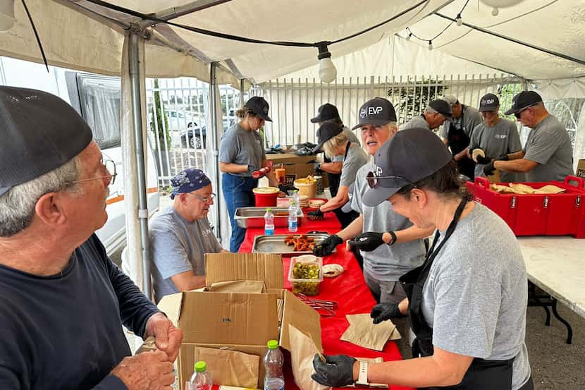 Volunteers for Dallas-based disaster relief organization Texas Baptist Men serve food in...