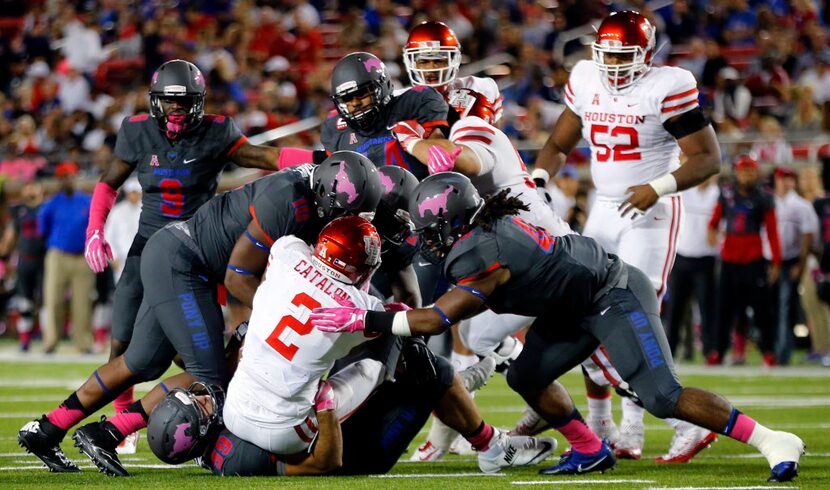 Houston Cougars running back Duke Catalon (2) is swarmed by the Southern Methodist Mustangs...