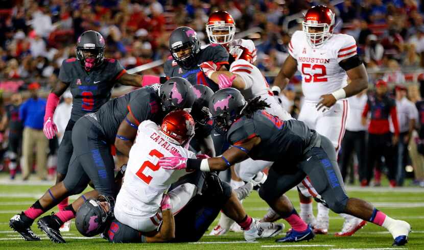 Houston Cougars running back Duke Catalon (2) is swarmed by the Southern Methodist Mustangs...
