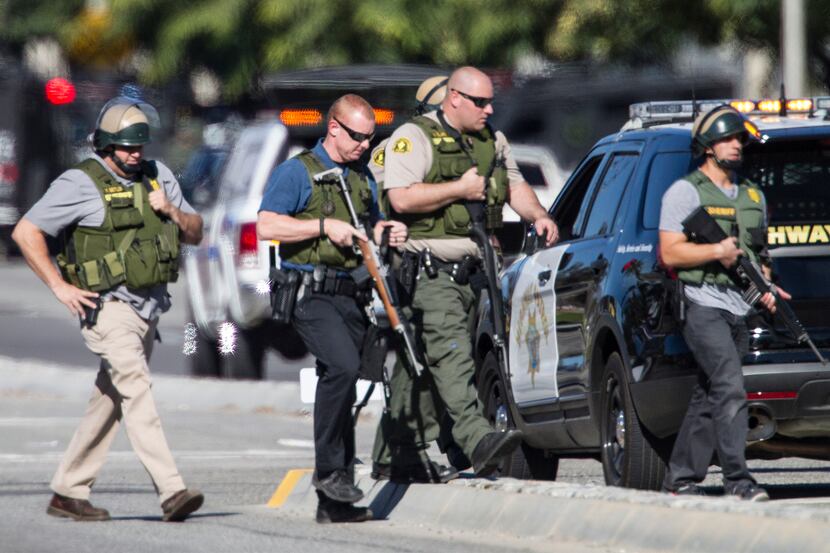 San Bernardino police officers in SWAT gear secured the scene at the Inland Regional Center...