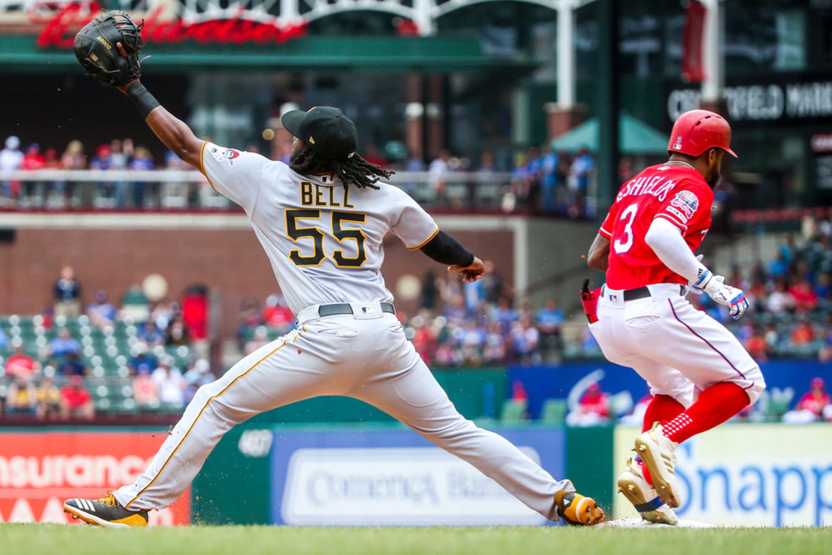 Texas Rangers left fielder Delino DeShields (3) makes it safe onto first base after...