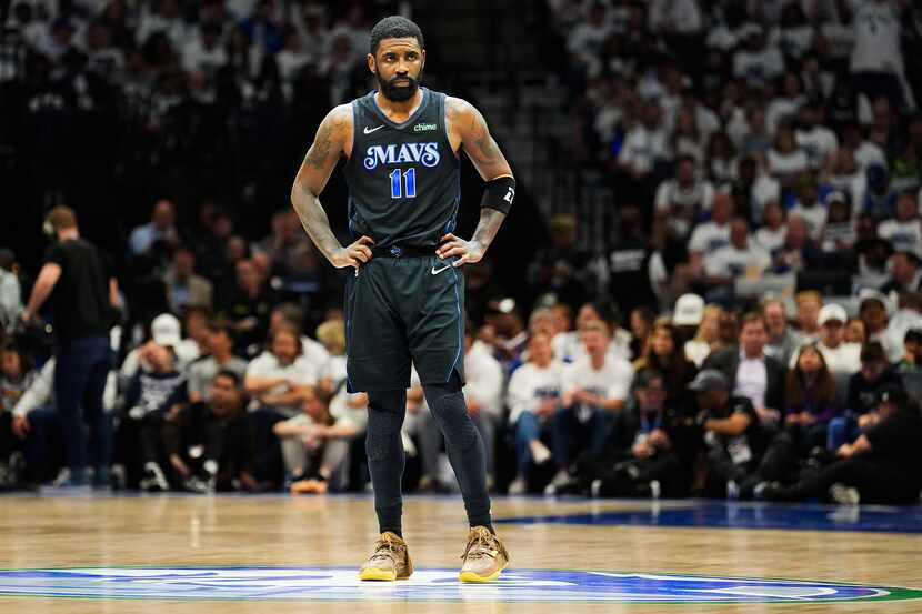 Dallas Mavericks guard Kyrie Irving  looks on during a timeout during the second half in...
