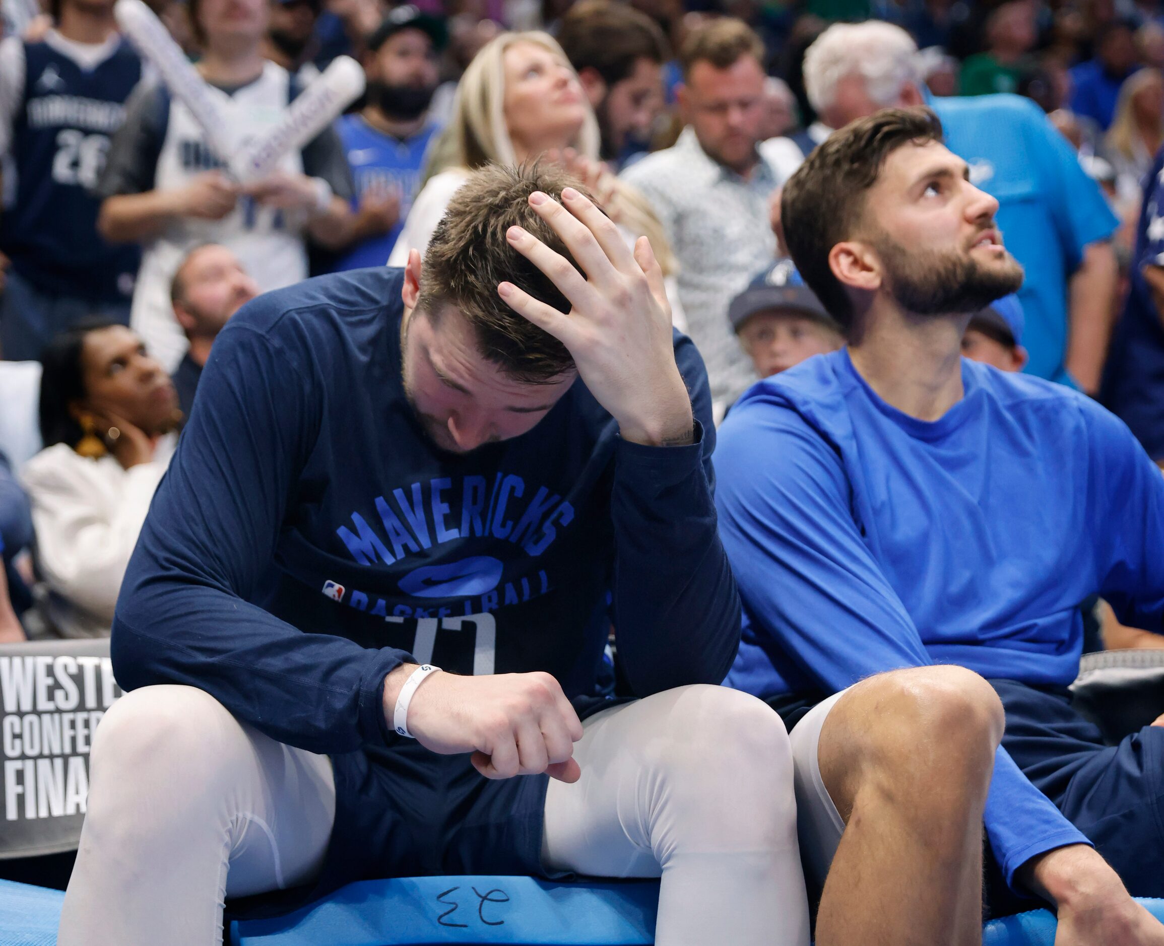 Dallas Mavericks guard Luka Doncic (77) sits on the bench in the third quarter as the team...