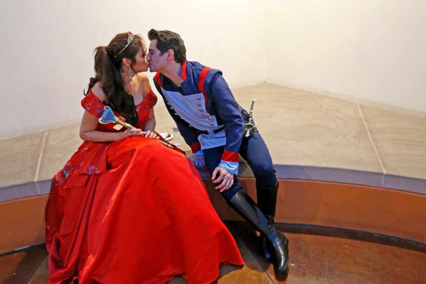 Elizabeth Sanchez (left), dressed as Princess Elena of Avalor, gets a kiss from her husband...