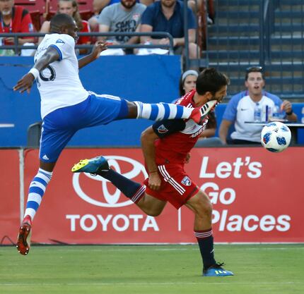 FC Dallas midfielder Ryan Hollingshead (12) takes a kick to the face from Montreal Impact...