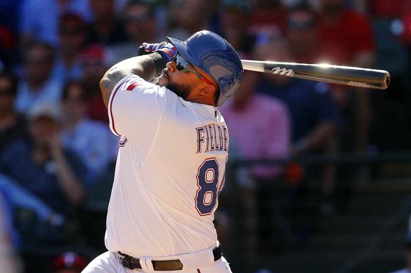 Texas Rangers designated hitter Prince Fielder (84) watches his bloop single in the fifth...