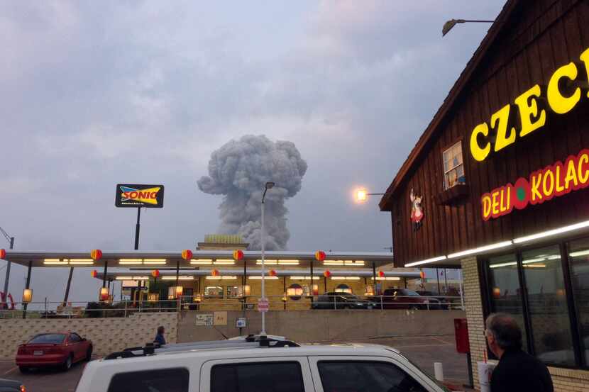 People at the Czech Stop look at a cloud of smoke rising from an explosion at a fertilizer...