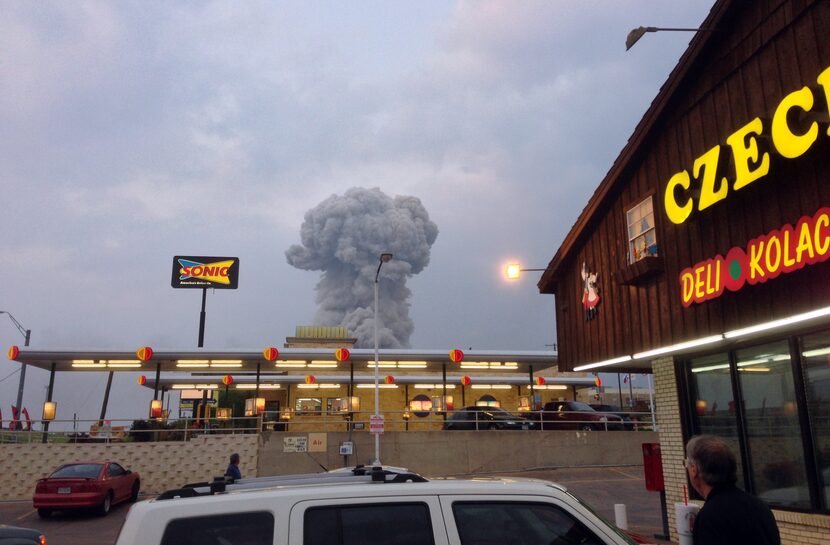 People at the Czech Stop look at a cloud of smoke rising from an explosion at a fertilizer...