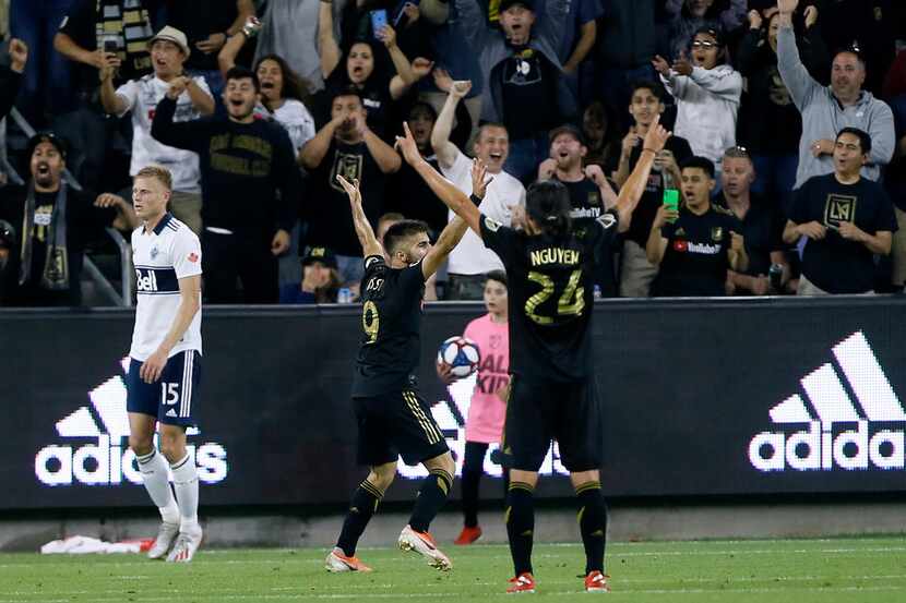 Los Angeles FC forward Diego Rossi (9) celebrates his goal with midfielder Lee Nguyen (24),...