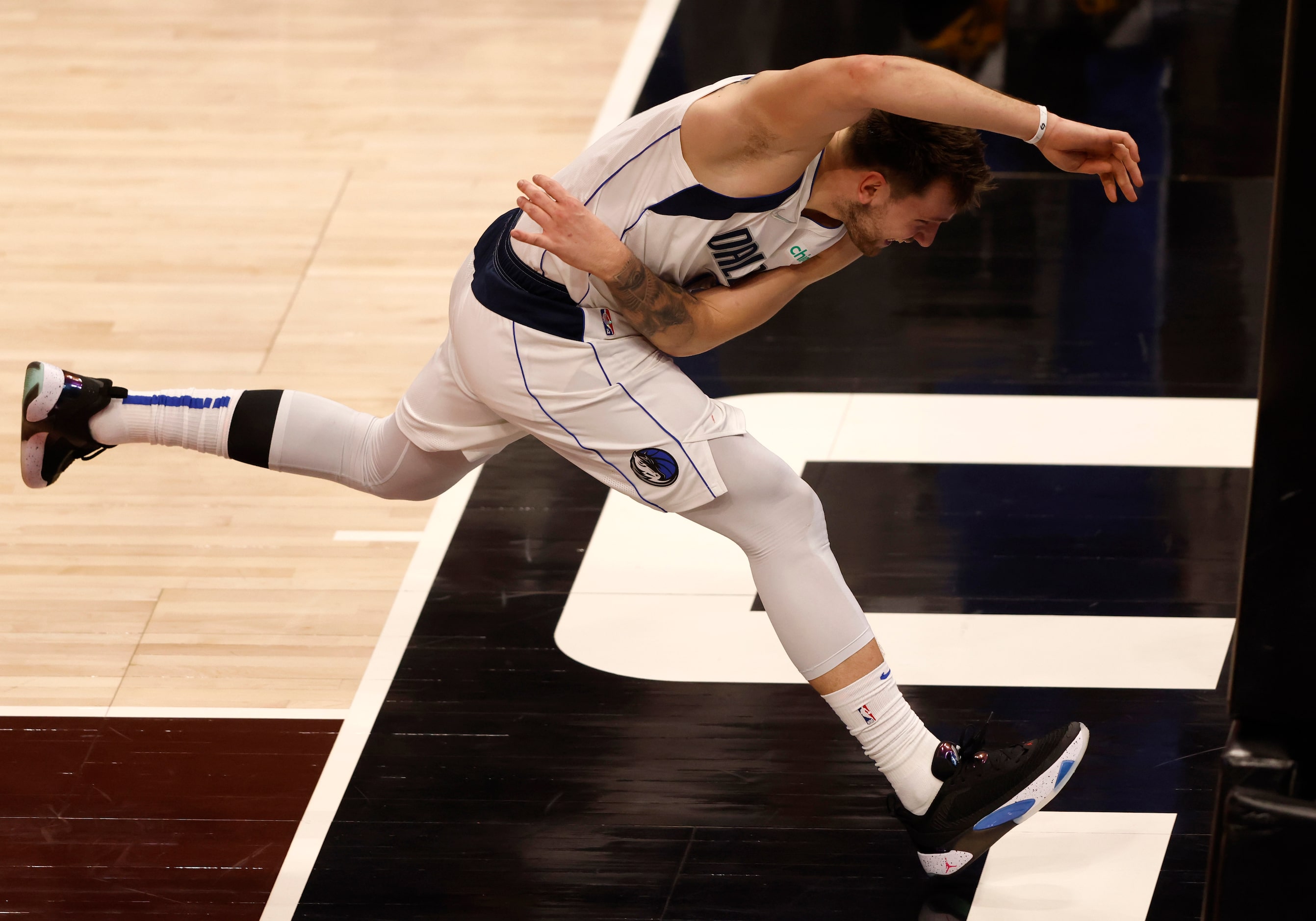 Dallas Mavericks guard Luka Doncic (77) goes after a loose ball during the third quarter of...