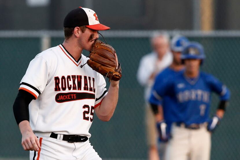Rockwall starting pitcher Brooks Helmer pitches against North Mesquite in their high school...