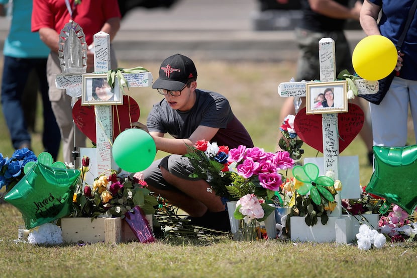 Mourners visit a memorial in front of Santa Fe High School on May 22, 2018 in Santa Fe,...