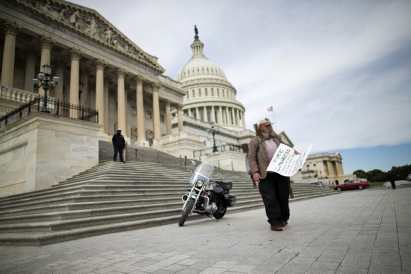 Rick Hohensee of Washington holds a "Fire Congress" sign near the House steps on Capitol...